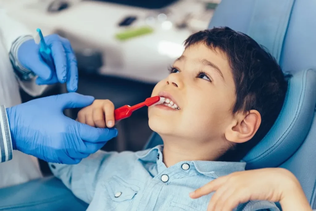 Child learning proper brushing technique during a dental visit in Summerville, SC.