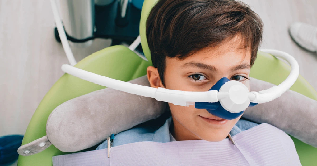 Child receiving nitrous oxide sedation in Knightsville & Carnes, SC at a dental clinic.