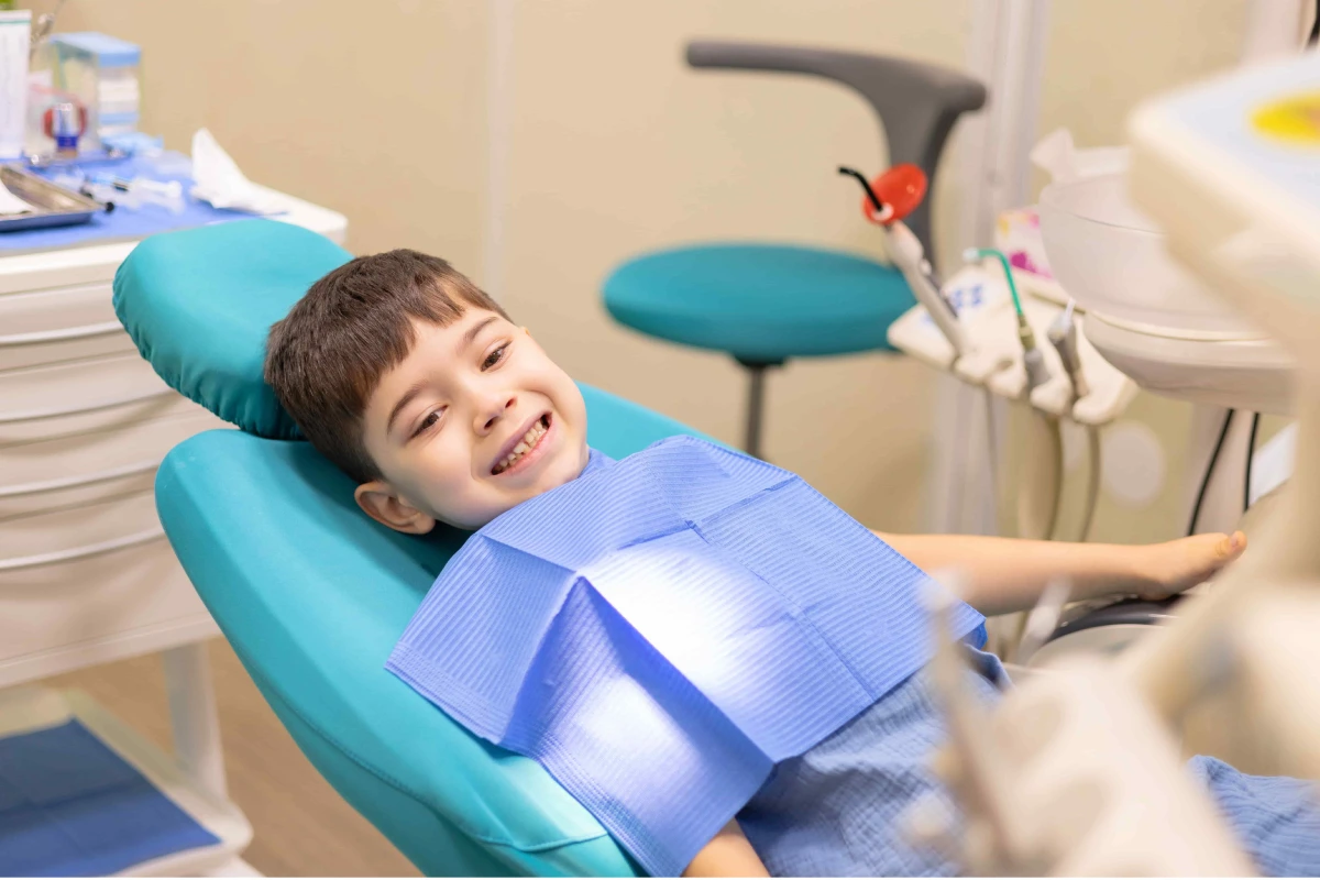 Child receiving gentle pediatric dental care before tooth removal in Summerville, SC.