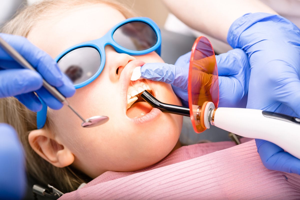 Dentist Performing Dental Filling Procedure to a Little Girl | Solomon Kids Dentistry in Carnes & Knightsville, SC